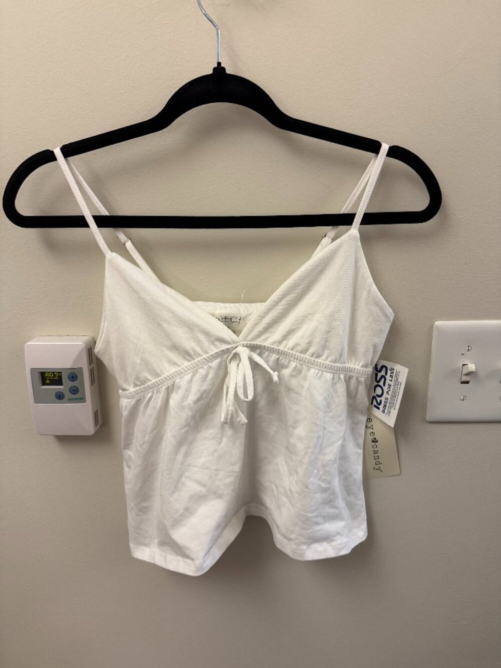 white v-neck tank top with bow on center chest